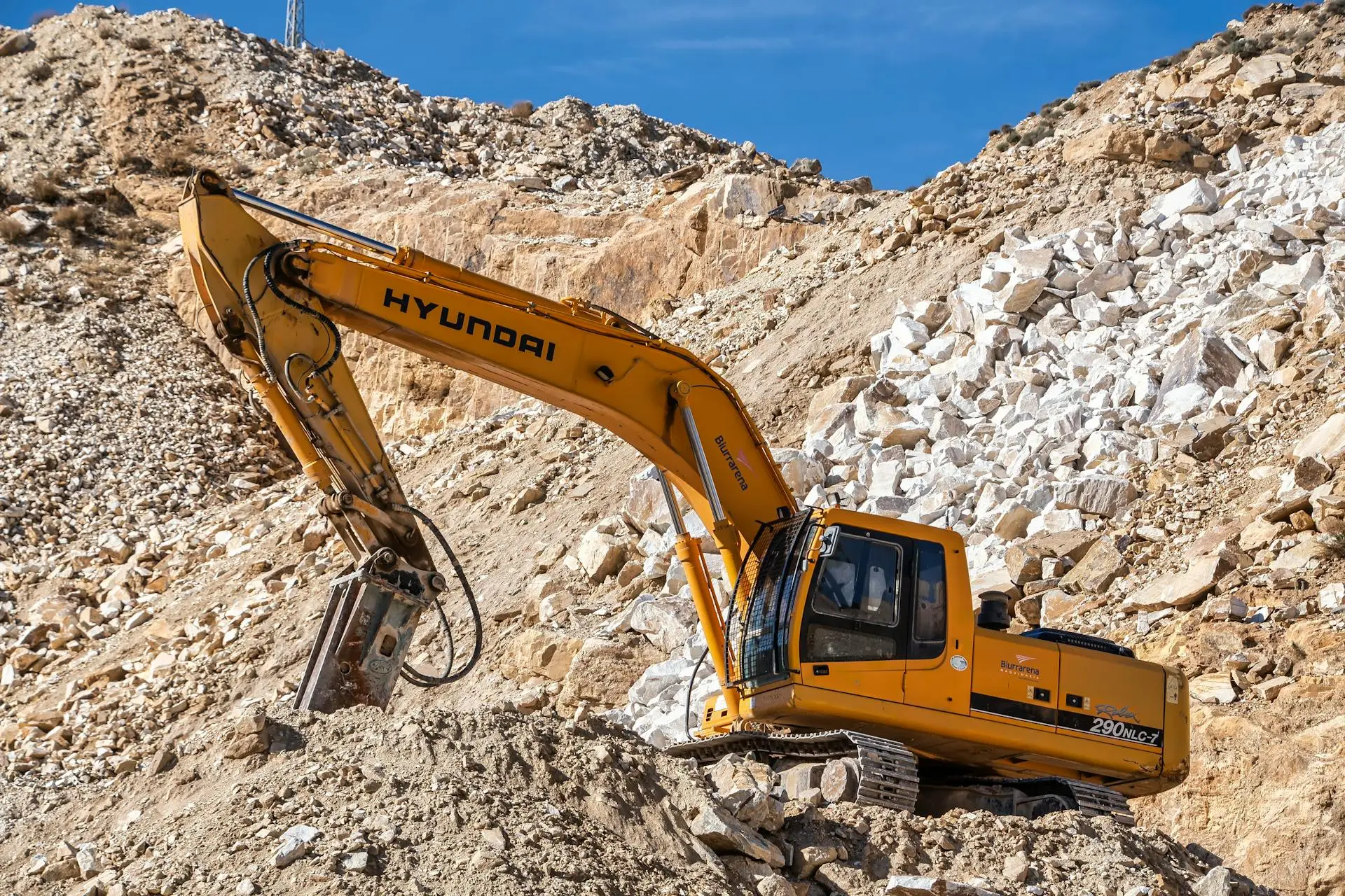 Excavator operating in a mine site representing mining services industry