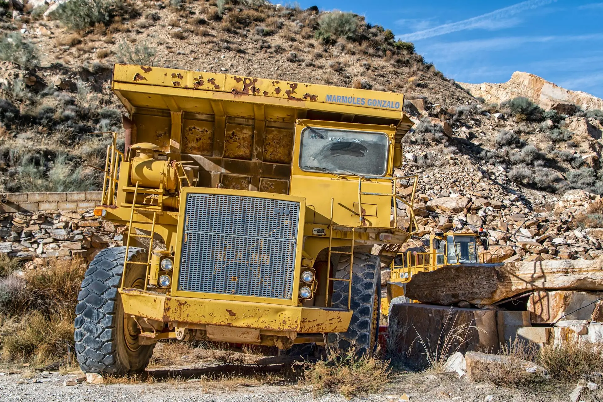 Heavy mining machinery operating in desert terrain representing mining services capabilities