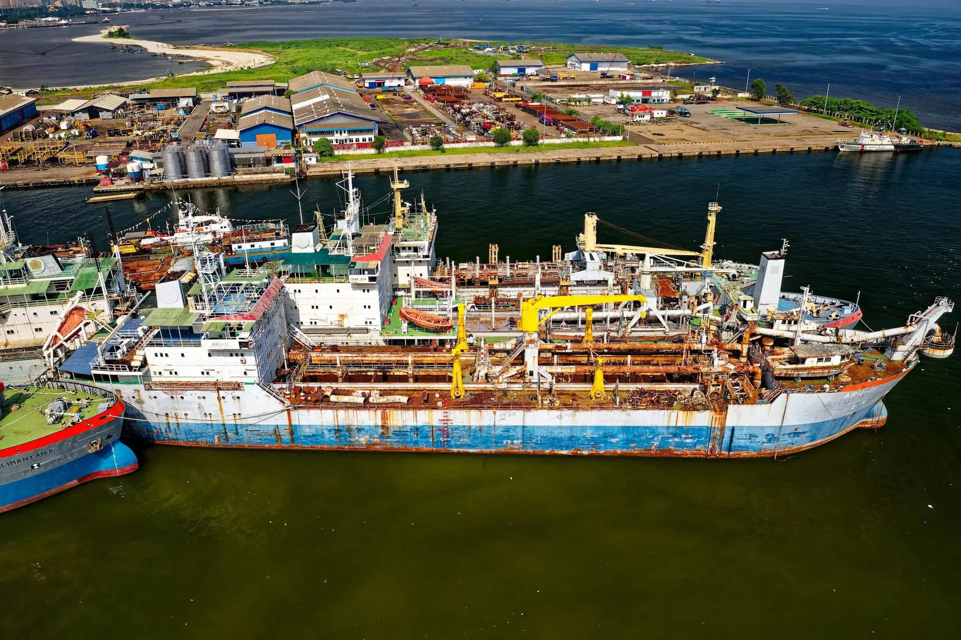Aerial view of a large vessel at a shipyard facility representing the marine repair industry