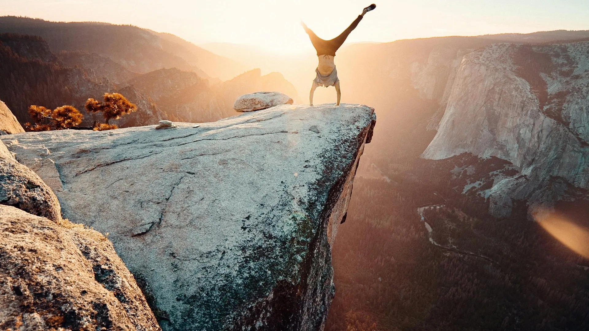 Person standing on mountain peak overlooking vast landscape — representing the visibility SEO website design delivers