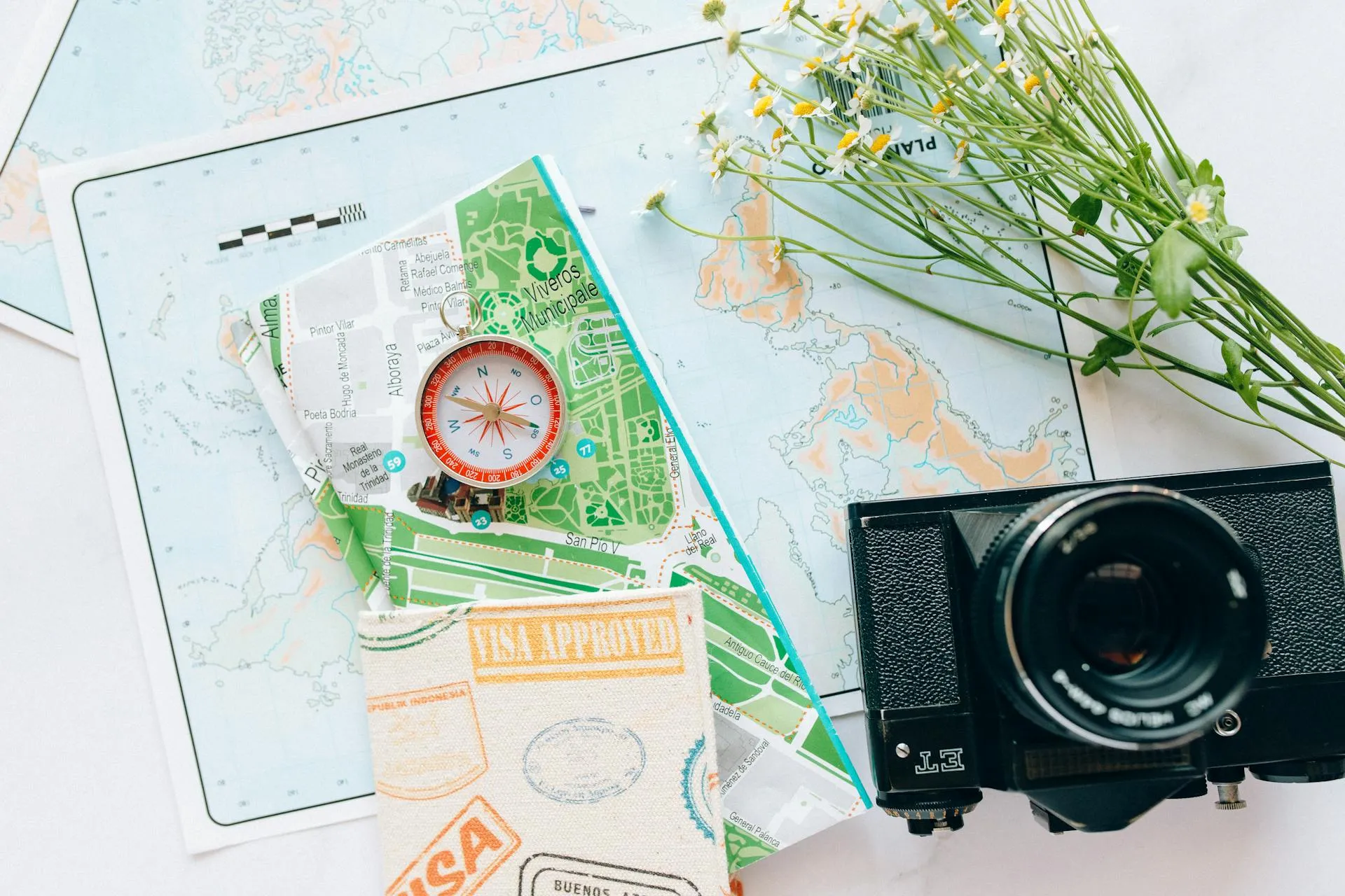 Compass beside map and camera representing strategic website planning and design
